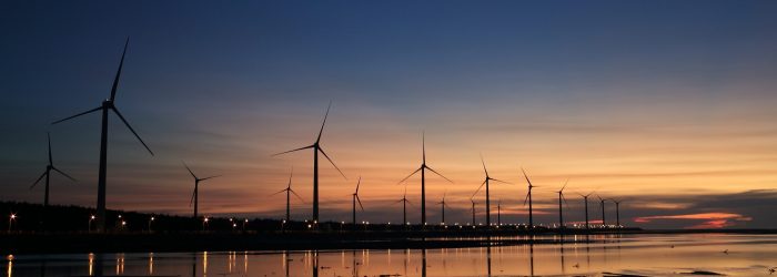 wind turbines on shore at dusk